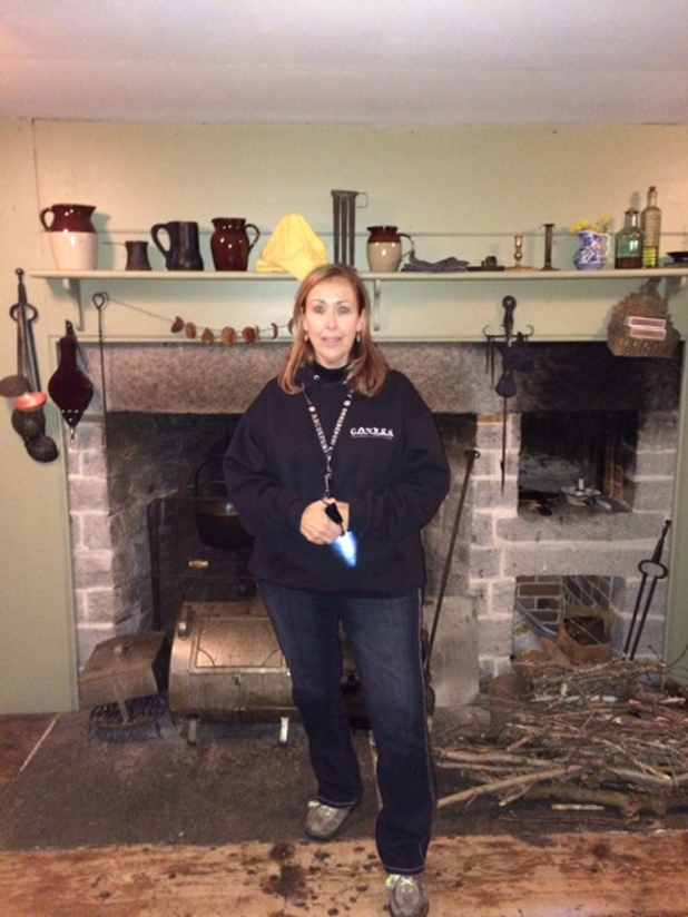 Psychic Medium Karen Hollis stands in front of the hearth at the Nathan Hale Homestead during the investigation